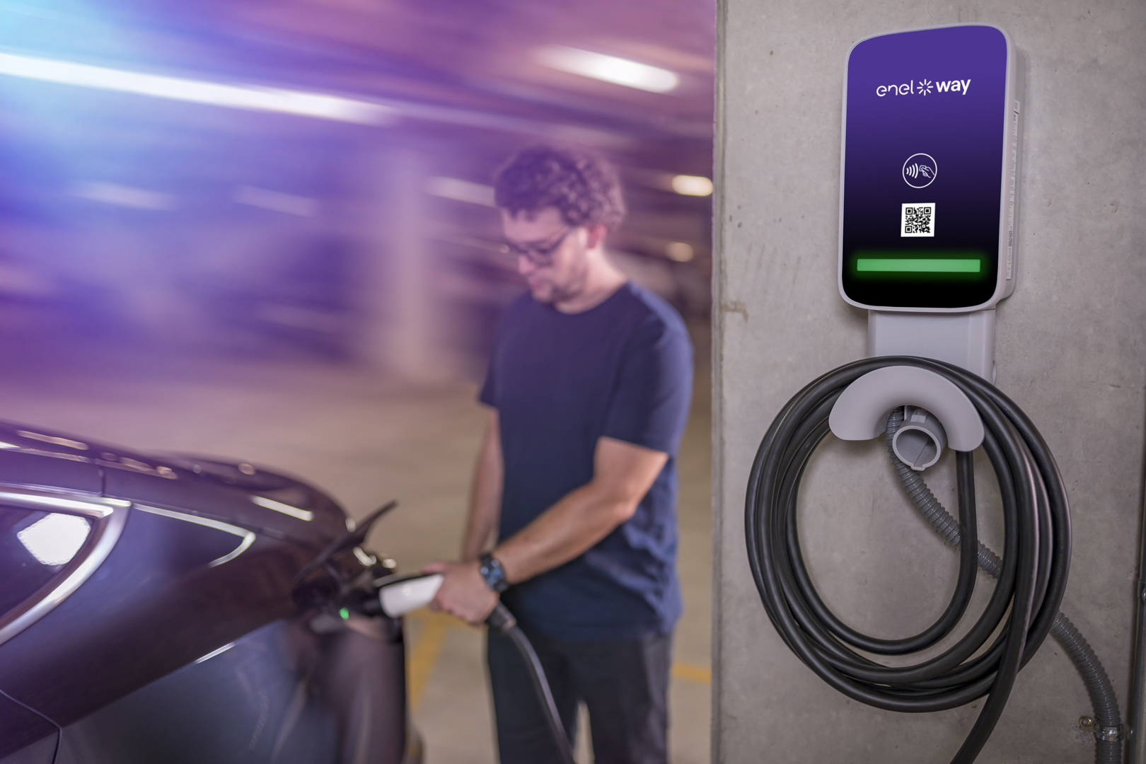 Man charging a Tesla Model 3 using JuiceBox Pro