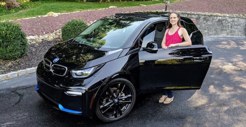 Woman standing by a car