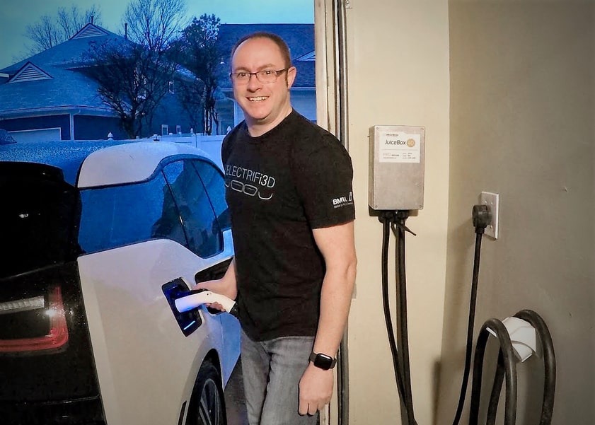 Man plugging in electric vehicle